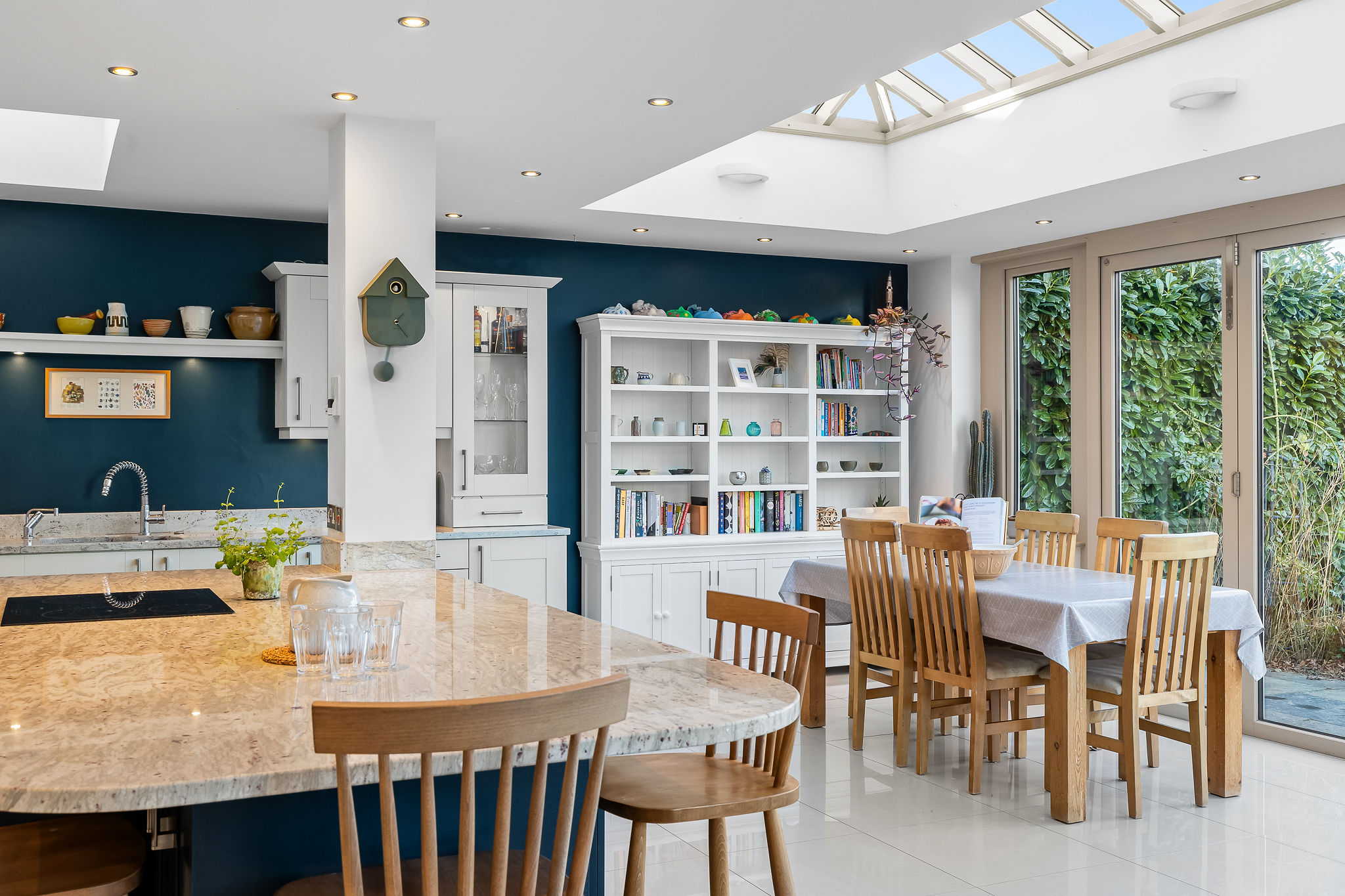 Open plan kitchen and dining area with skylight