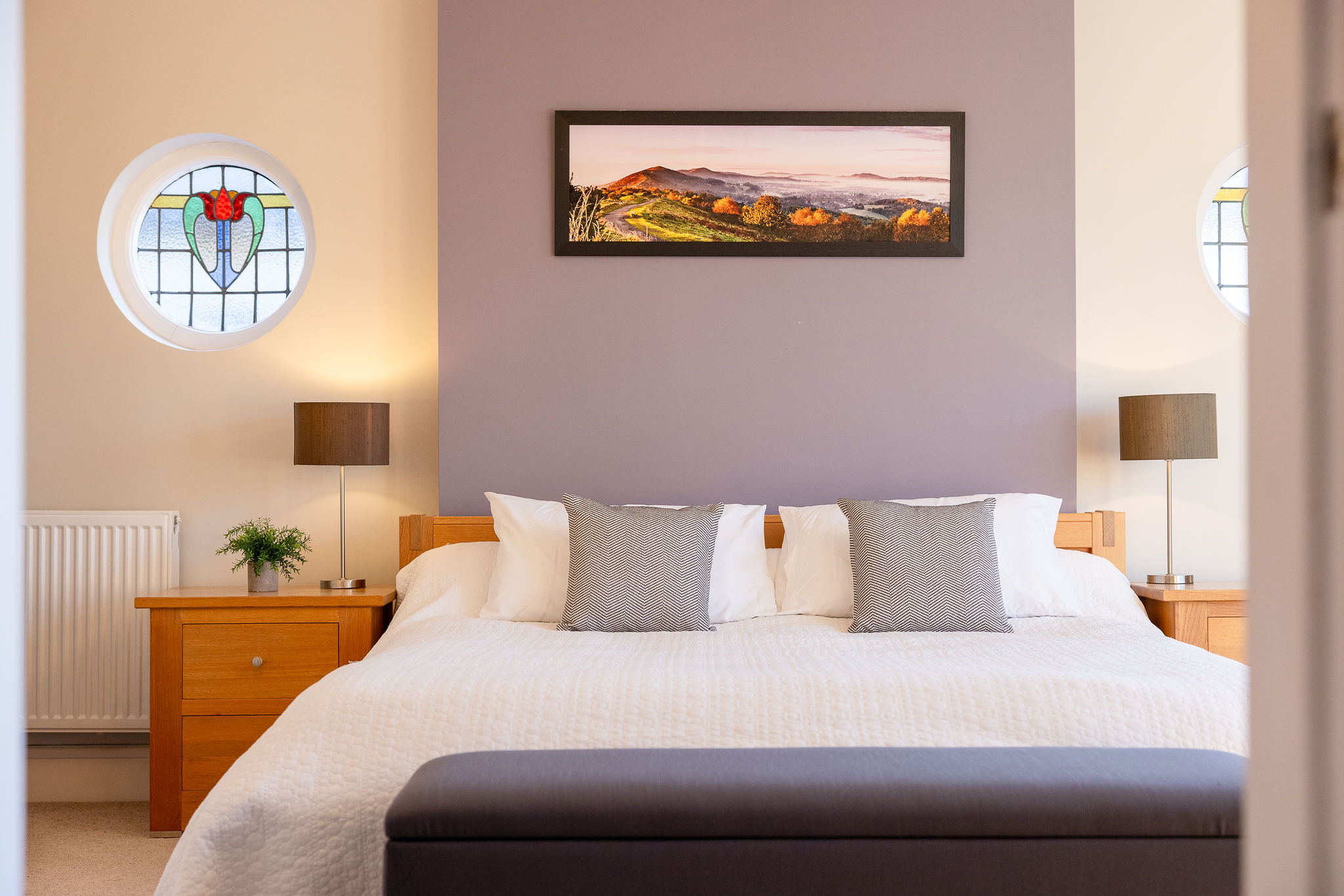 Stylish bedroom with landscape artwork