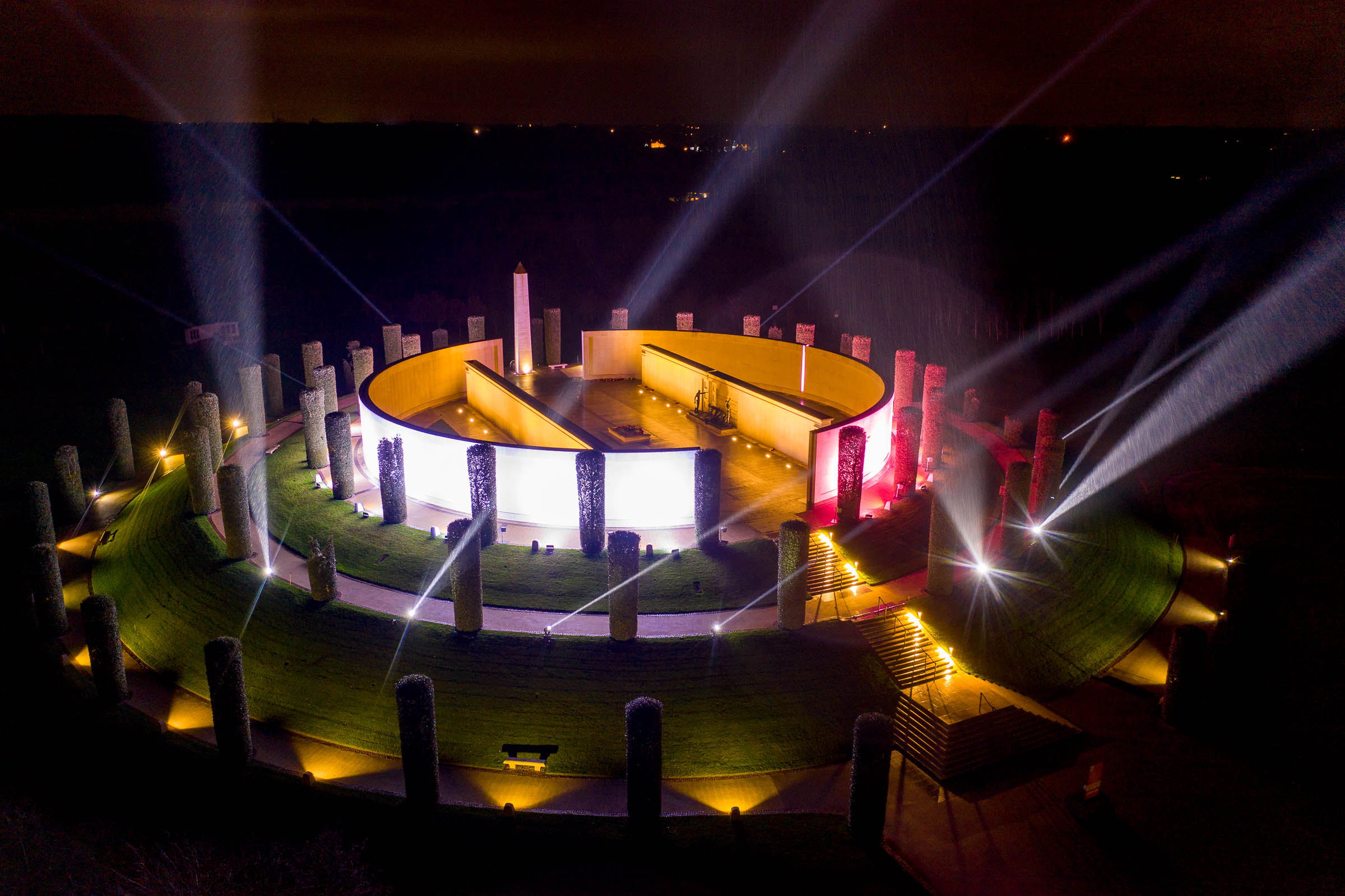 Illuminated circular architectural structure at night