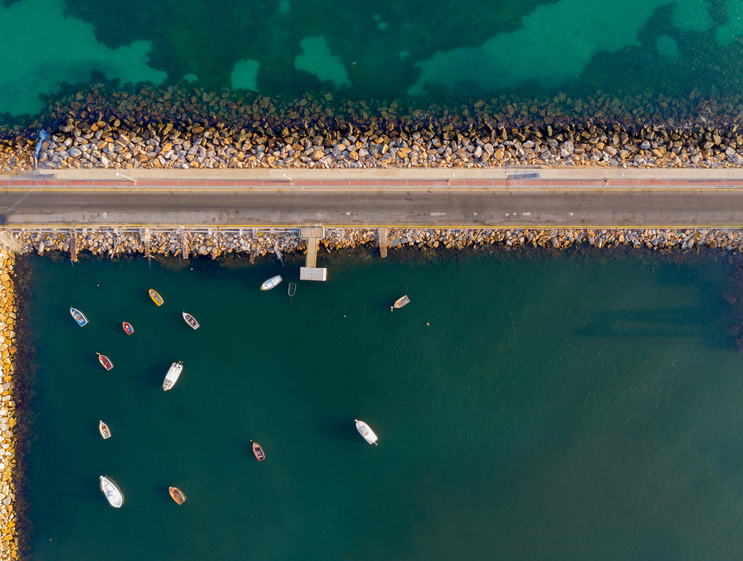Aerial view of harbor pier with moored boats