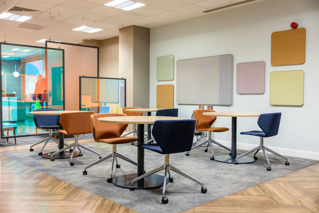 Vibrant commercial collaborative workspace with colorful chairs at Brindley Place