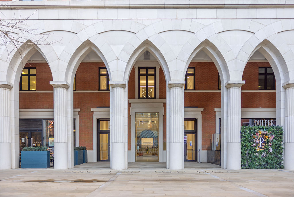 Impressive commercial building entrance with classical arched facade